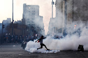 A demonstrator kicks a tear gas canister during a protest against Peru's President Pedro Castillo after he had issued a curfew mandate which was lifted following widespread defiance on the streets, as protests spiraled against rising fuel and fertilizer prices triggered by the Ukraine conflict, in Lima, Peru April 5, 2022. 