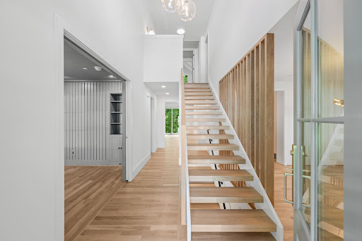 Modern staircase with wooden railing in this luxury house for sale in Bethesda ($2,295,000)