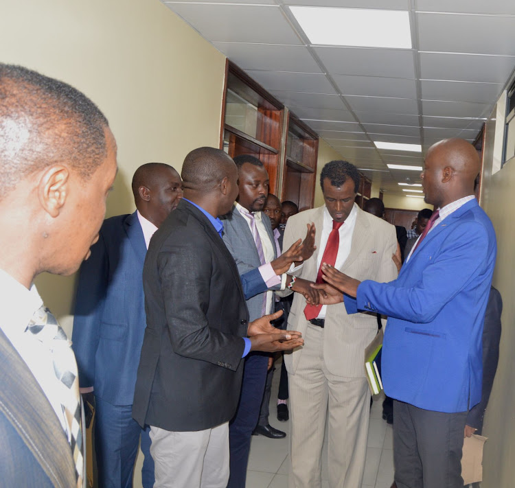 Nairobi County Chief Officer for Finance Halkano Waqo (centre) being approached by angry MCAs at City Hall on June 26,2019