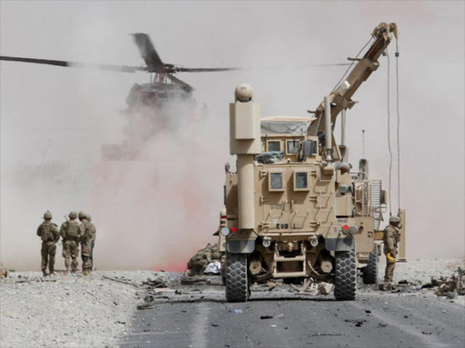 US troops assess the damage to an armoured vehicle of NATO-led military coalition after a suicide attack in Kandahar province, Afghanistan August 2, 2017. /REUTERS