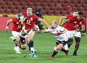 British & Irish Lions captain Stuart Hogg tries to break away from Vincent Tshituka and Dillon Smit of the Sigma Lions  at Ellis Park on Saturday.