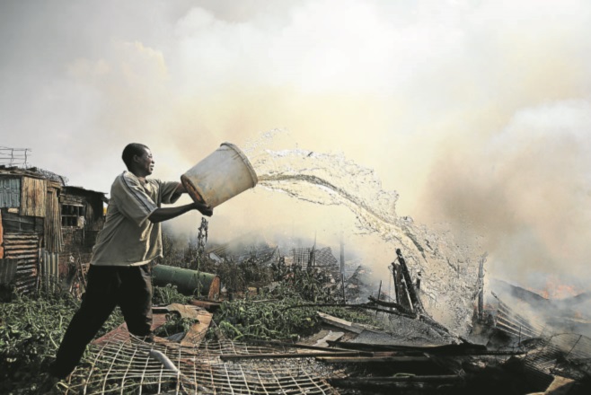 Putting out fires in Ramaphosa squatter camp east of Johannesburg. May 19 2008.