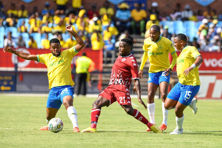 Victor Letsoalo of Sekhukhune United is challenge by Sipho Mbhule, Thapelo Morena and Andile Jali of Mamelodi Sundowns during the DStv Premiership match at Loftus Versfeld Stadium on January 28, 2023.