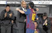 DREAM TEAM: Barcelona's Lionel Messi celebrates his fourth goal with coach Pep Guardiola against Espanyol during their La Liga match at Nou Camp stadium in Barcelona on Saturday. Photo: REUTERS