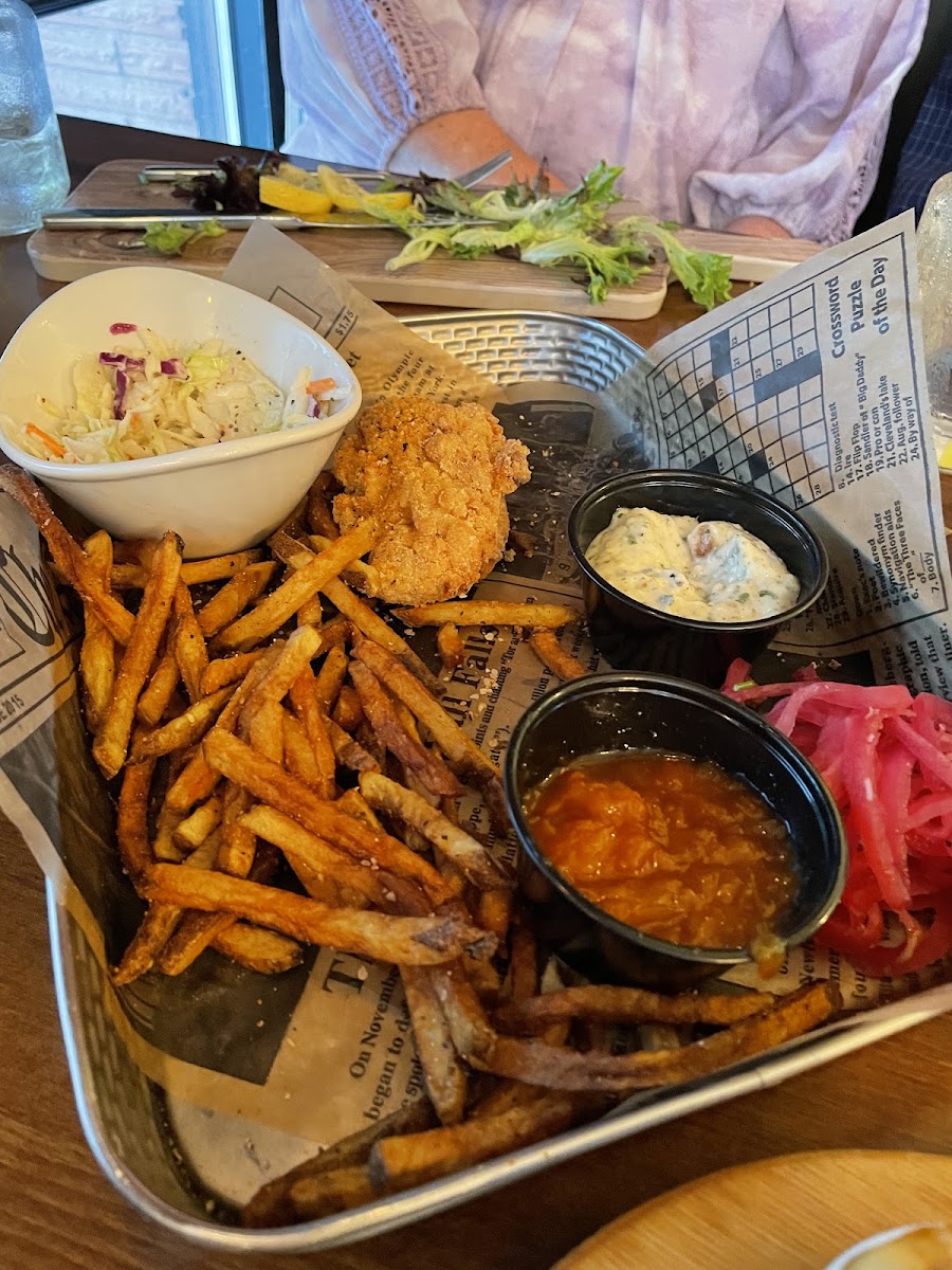 Half eaten chicken strips, fries, and coleslaw. So good!! All of their sauces are wonderful. Pictured is ranch and peach bbq sauces