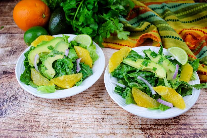 Two Plates Of Avocado Citrus Salad.