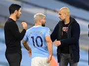 Manchester City's Sergio Aguero with manager Pep Guardiola after being substituted as Arsenal manager Mikel Arteta looks on.