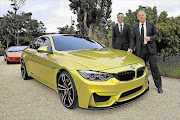 BMW M4 exterior designer Florian Nissl, left, and Dr Friedrich Nitschke, president BMW M Division at the BMW Concept M4 coupé showing at Pebble Beach, California