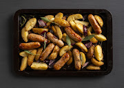 Rosemary roasted sausage and potato wedge tray bake.