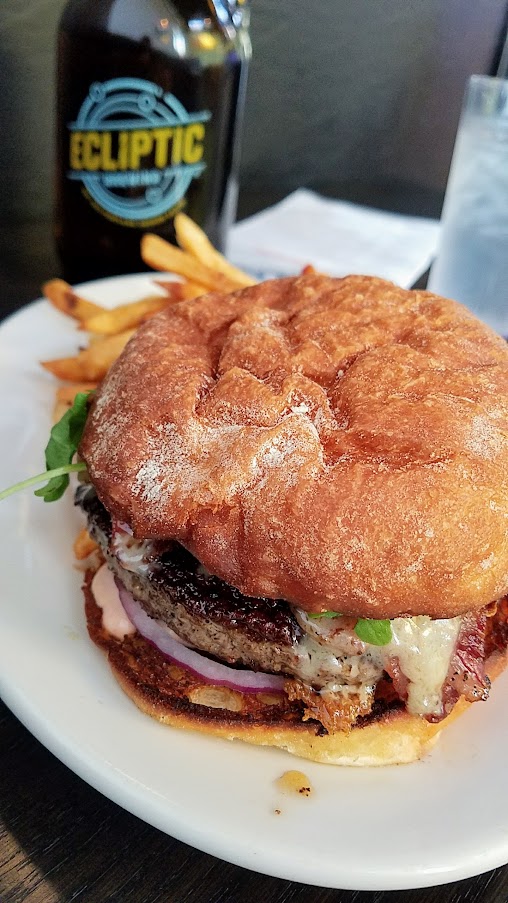 The Ecliptic Burger with 1/2 pound of beef, pancetta, red onion, aged gruyere, russian dressing, potato bun