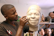 Wax sculptor Lungelo Gumede working on his sculpture of Nkosazana Dlamini-Zuma.