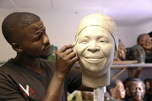 Wax sculptor Lungelo Gumede working on his sculpture of Nkosazana Dlamini-Zuma.