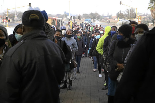 Passengers queue for transport at the Rea Vaya bus stop in Soweto during Level 4 of the lockdown.