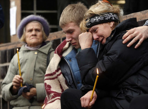 Outside the Maxima supermarket in Riga, Latvia, people mourn the dozens of people killed in the initial collapse.