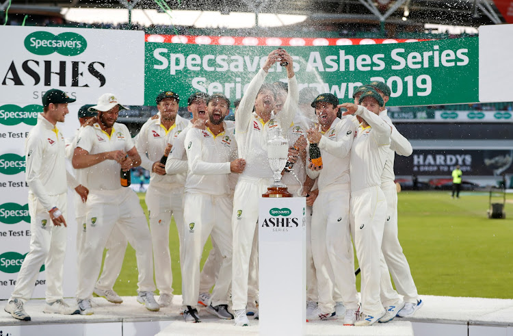 Australia's Tim Paine holds up the Ashes urn as Australia celebrate retaining the Ashes against England at the Oval in London in September 2019.