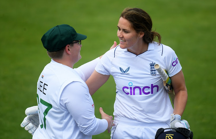 England's Nat Sciver, after finishing unbeaten on 169, embraces Lizelle Lee of SA as they leave the field on day Three of the first Test at The County Ground in Taunton, England on June 29 2022.