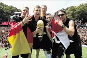 PARTY ON:  Bastian Schweinsteiger, Per Mertesacker, Manuel Neuer, Kevin Grosskreutz and Lukas Podolski  celebrate on stage at yesterday's German  victory ceremony in Berlin 
      
      
      
      Photo: Alex Grimm/Getty Images