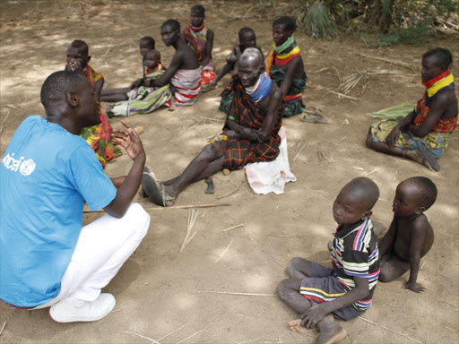 Unicef good will ambassador Kevin Umbima with residents of Nakodet in Turkana County while attending screening and treatment of children suffering from malnutrition on Junly 12, 2017.