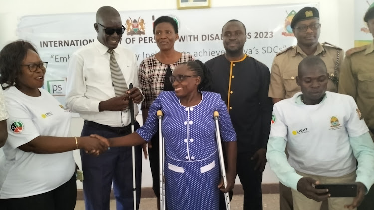 Gender and social affairs stakeholders Dolphin Ochere, Paul Nyari, Sarah Malit, Maslin Ngala, Charles Mwayaya when they marked International Day of persons with disabilities at Kabunde in Homa Bay town on December 5,2023