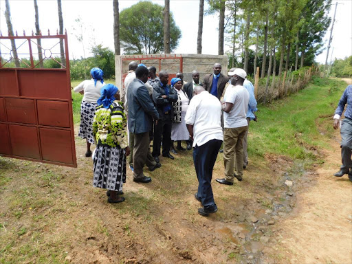 Nyandarua Central OCPD Wilson Kosgei (in white cap) addresses a group of worshipers at Nyakiambi AIPCA church, Ol kalou, urging them to keep peace. /Ndichu Wainaina