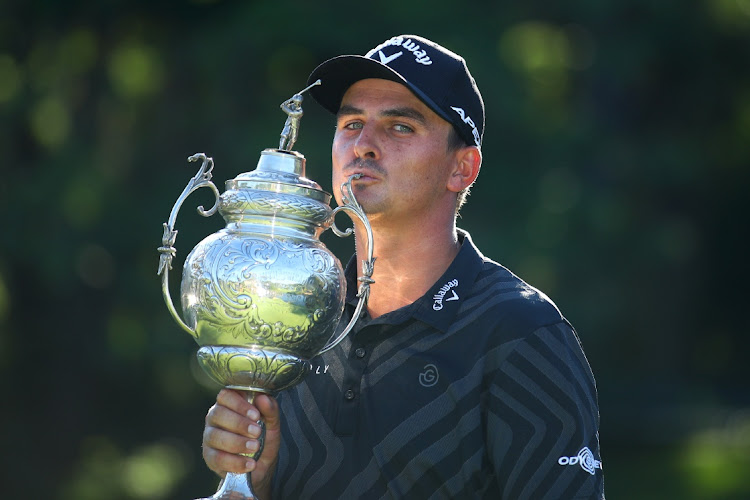 Christian Bezuidenhout kisses the trophy after his victory in the South African Open at the Gary Player Country Club on Sunday in Sun City