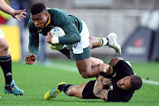 South Africa's Aphiwe Dyantyi is tackled by New Zealand's Aaron Smith on his way to scoring during a Rugby Championship match between the Springboks and New Zealand at Westpac Stadium in Wellington on September 15, 2018.