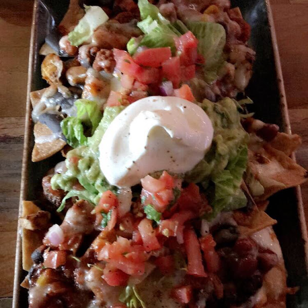 Chicken chili nachos. Gluten free fried chips and tons of toppings including guacamole, cheese, vegan chili, beans, chicken, pico de Gallo and I’m sure I’m forgetting something. But super delicious