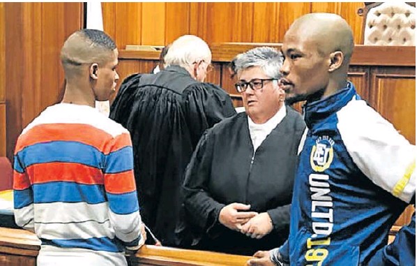 Eston Afrikaner, left, speaks to Advocate Jodine Coertzen while Deswin Kleinbooi faces the gallery after the presentencing hearing in the high court