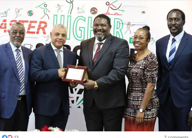 Paris 2024 Team Kenya chef de mission Shadrack Maluki presents a plague to WADA Africa director, Rodney Swingelaar (2nd L) as Nock officials Waithaka Kioni (L), Humphrey Khayange (R) and DAK CEO Sarah Shibutse look on