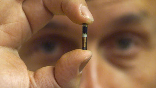 Professor Kevin Warwick holds a microchip August 26, similar to the one implanted into his arm. Prof..