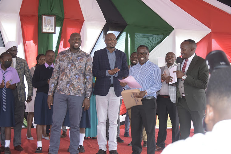 Roads and Transport CS Kipchumba Murkomen with his Trade counterpart Moses Kuria and Gatundu North MP Elijah Njoroge (right) during the issuance of Sh48 million bursary funds in Mang'u, Gatundu North on Friday, April 21, 2023.