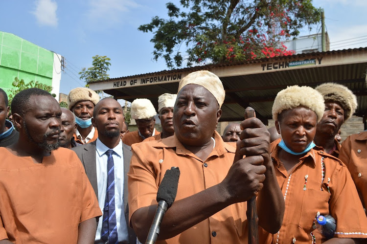 Ngumi Gitau chairman Kiama kia Ma in Ndeiya subcounty joined by other elders addressing the press outside Kiambu law courts on Tuesday. image: STANLEY NJENGA