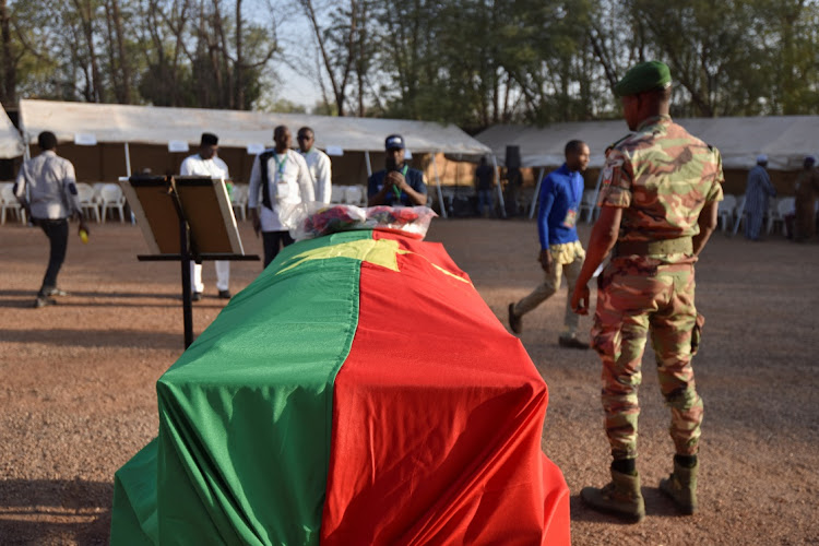 A military officer stands in front of the coffin containing the remains of Thomas Sankara, in Ouagadougou, Burkina Faso February 23 2023. Picture: ANNE MIMAULT