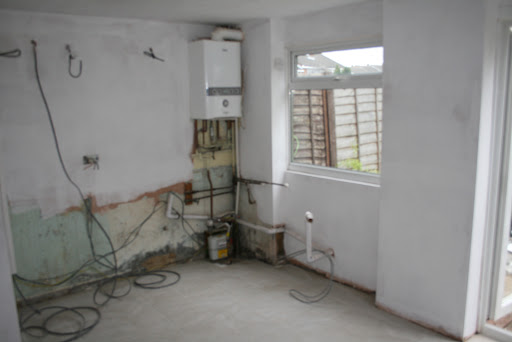 Area emptied, electrics run for new oven and induction hob and plumbing adapted for new Washing machine and dishwasher.
