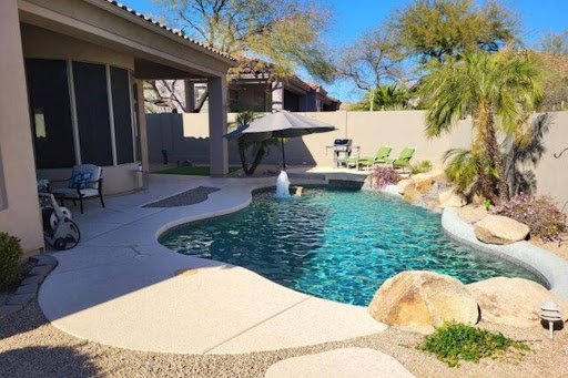 Pool with waterfall and lounge chairs in this luxury house for sale in Scottsdale ($900,000)