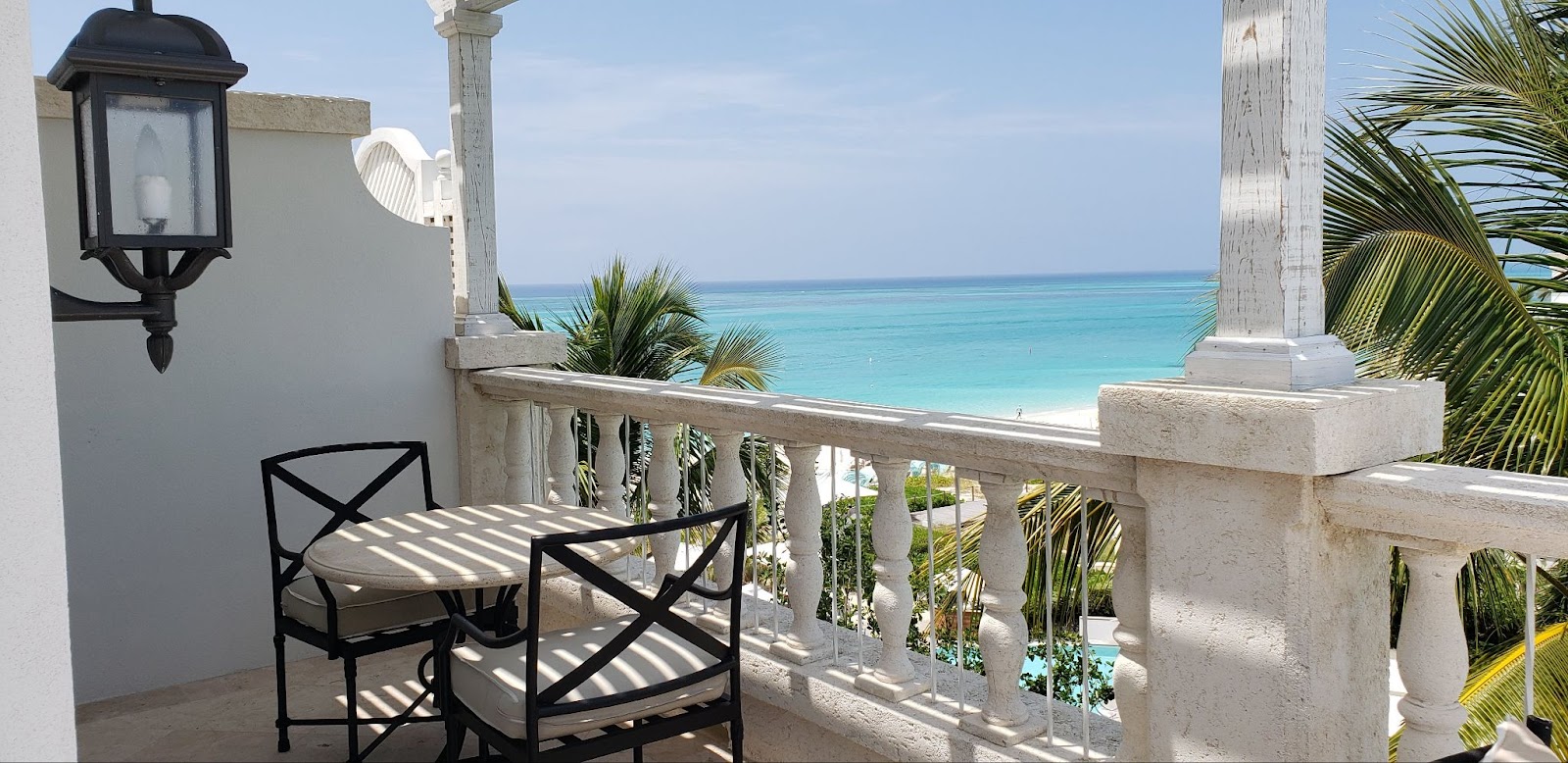 a balcony with a view of the beach and ocean at The Palms on Provo.