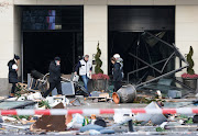 Emergency services work after the AquaDom aquarium in central Berlin burst, causing water to pour out onto the street.