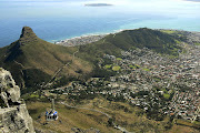 A view of the cablecar, Lion's Head, Signal Hill and Cape Town from Table Mountain with Robben Island in the distance. File photo