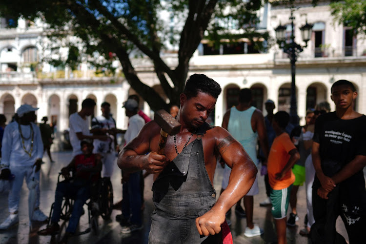 Cuba's 'Ironman' Lino Tomasen performs in downtown Havana, Cuba, on August 8 2023.