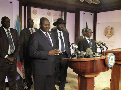 South Sudan First Vice President Riek Machar (L), flanked by South Sudan President Salva Kiir (C) other government officials, addresses a news conference at the Presidential State House in Juba, South Sudan, July 8, 2016. REUTERS/Stringer