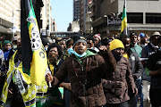 Suspended ANC secretary-general Ace Magashule’s supporters sing and dance outside the South
Gauteng High Court in Johannesburg. 