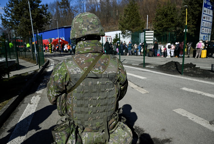 An officer stands guard at the border crossing, after Russia launched a massive military operation against Ukraine, in Ubla, Slovakia, February 27, 2022.