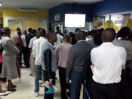 Customers of Chase Bank's Rafiki Deposit-Taking Microfinance gather at its Biashara Street offices in Nairobi following the bank's placement under receivership over liquidity problem, April 7, 2016. Photo/ENOS TECHE