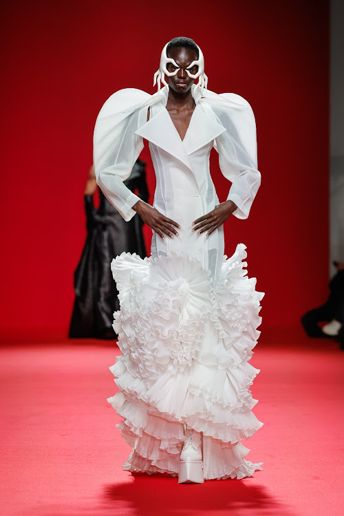 Model walks the runway in Robert Wun ensemble.