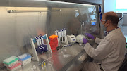 A technician inspects vials of coronavirus disease (Covid-19) vaccine candidate BNT162b2 at a Pfizer manufacturing site in manufacturing site in St. Louis, Missouri, US in an undated photograph.  