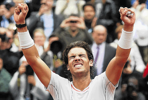 Rafael Nadal of Spain celebrates defeating compatriot David Ferrer in the men's singles final at the French Open tennis tournament in Paris yesterday to become the first man to win a Grand Slam title eight times