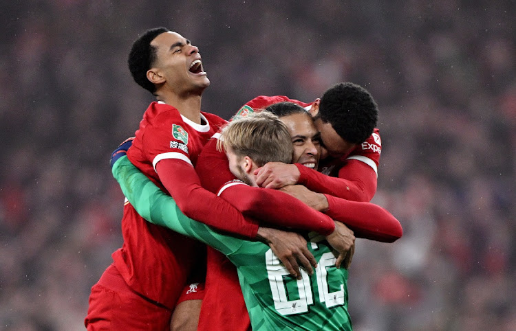 Cody Gakpo, scorer Virgil van Dijk and Caoimhin Kelleher of Liverpool celebrate after their victory in the League Cup final against Chelsea at Wembley Stadium in London on Sunday.