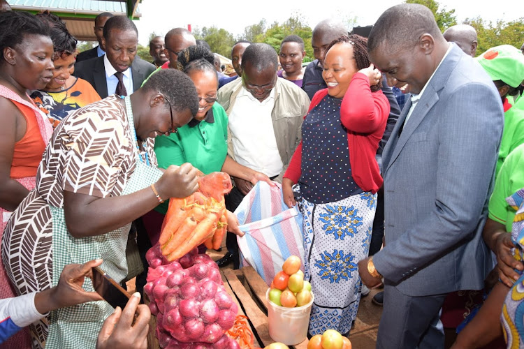 Kirinyaga Governor Anne Waiguru buys groceries from traders at the newly opened Makutano market, November 23, 2022.