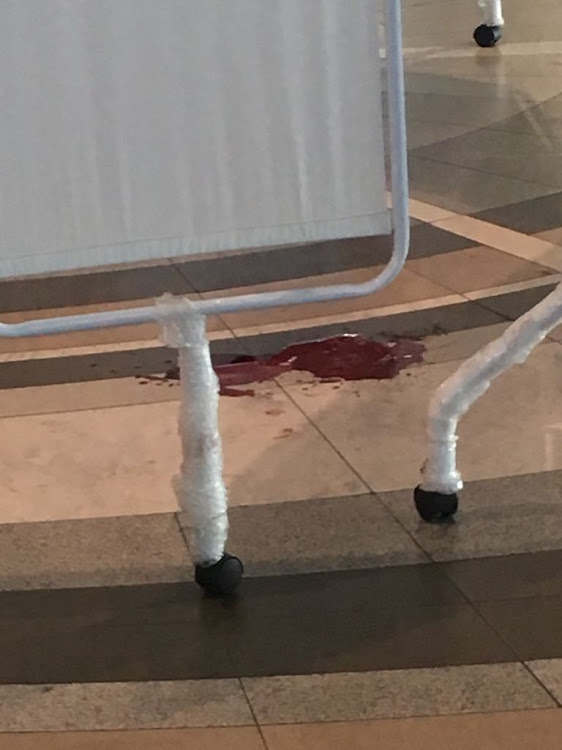 Blood on floor of the departures terminal at Cape Town International Airport.