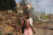  Residents of Inanda clear their road after it was blockaded by protesters.  